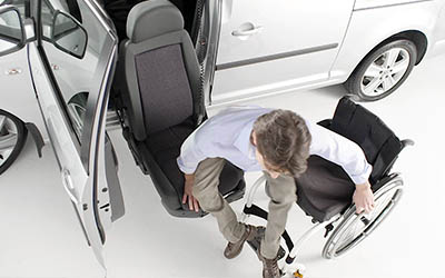 Top view of a man transfering from wheelchair into a Turny